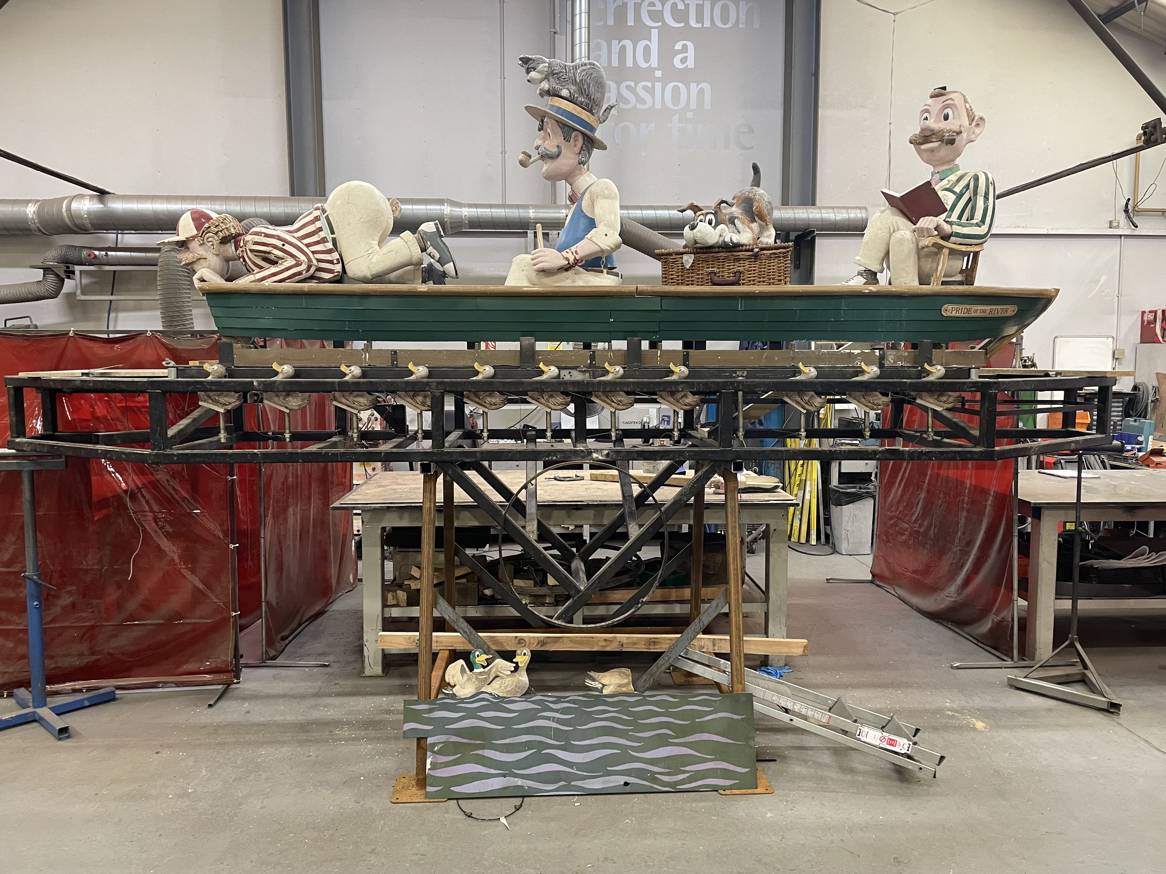 The three men in a boat automaton standing on a frame in a workshop