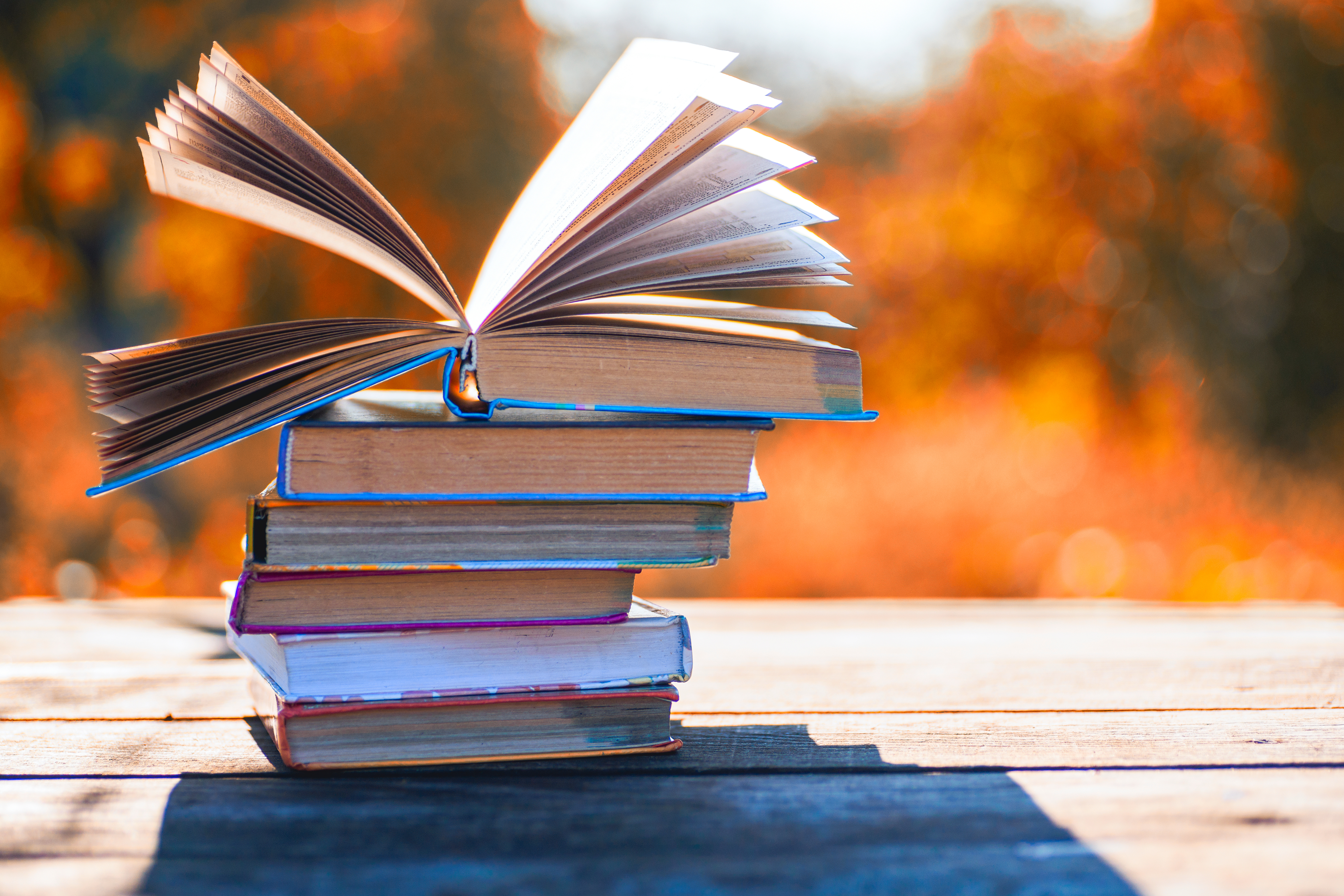 pile of books on a table, outside