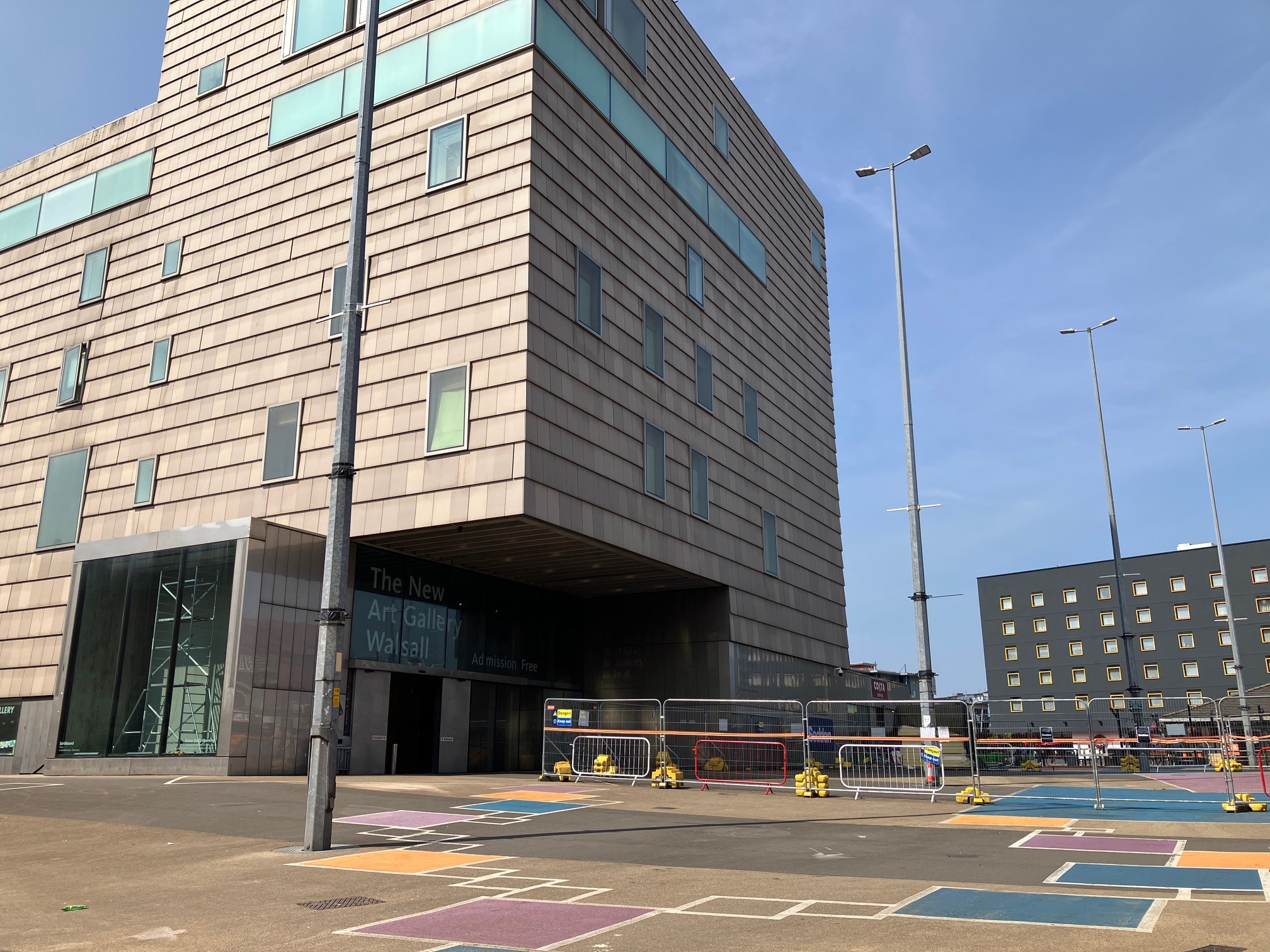 View of The New Art Gallery Walsall from Gallery Square with fencing in the square