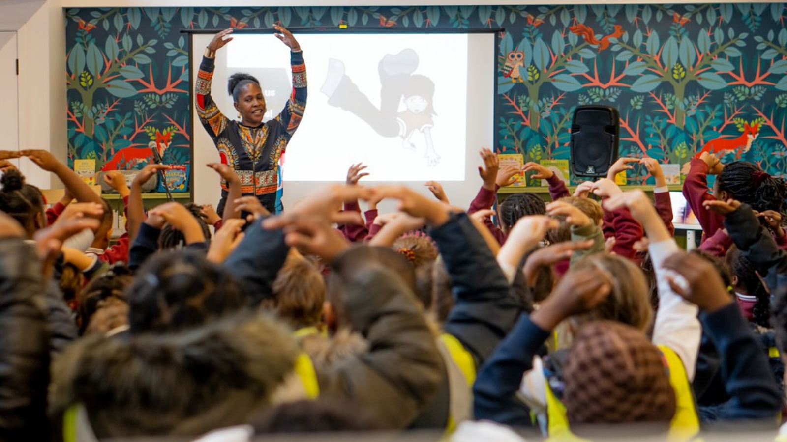 Black British Ballet Exhibition session, teacher showing dance moves to children