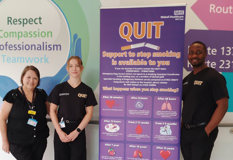 Image depicts three NHS colleagues from Walsall Manor Hospital's Tobacco Dependency team next to a QUIT banner.
