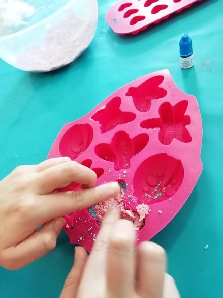 person creating leaf shapes on paper