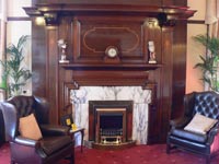parlour room with fireplace and chairs