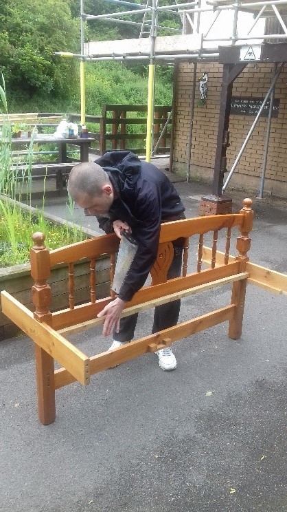 A man fixing a bench 