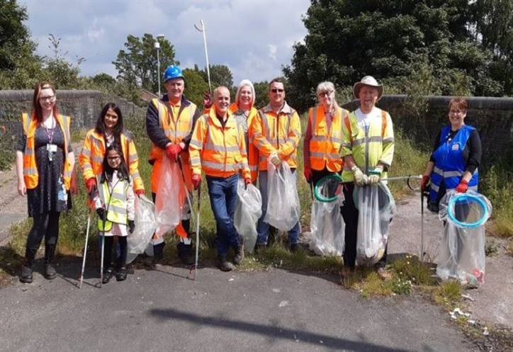litter pickers in yellow high vis jackets