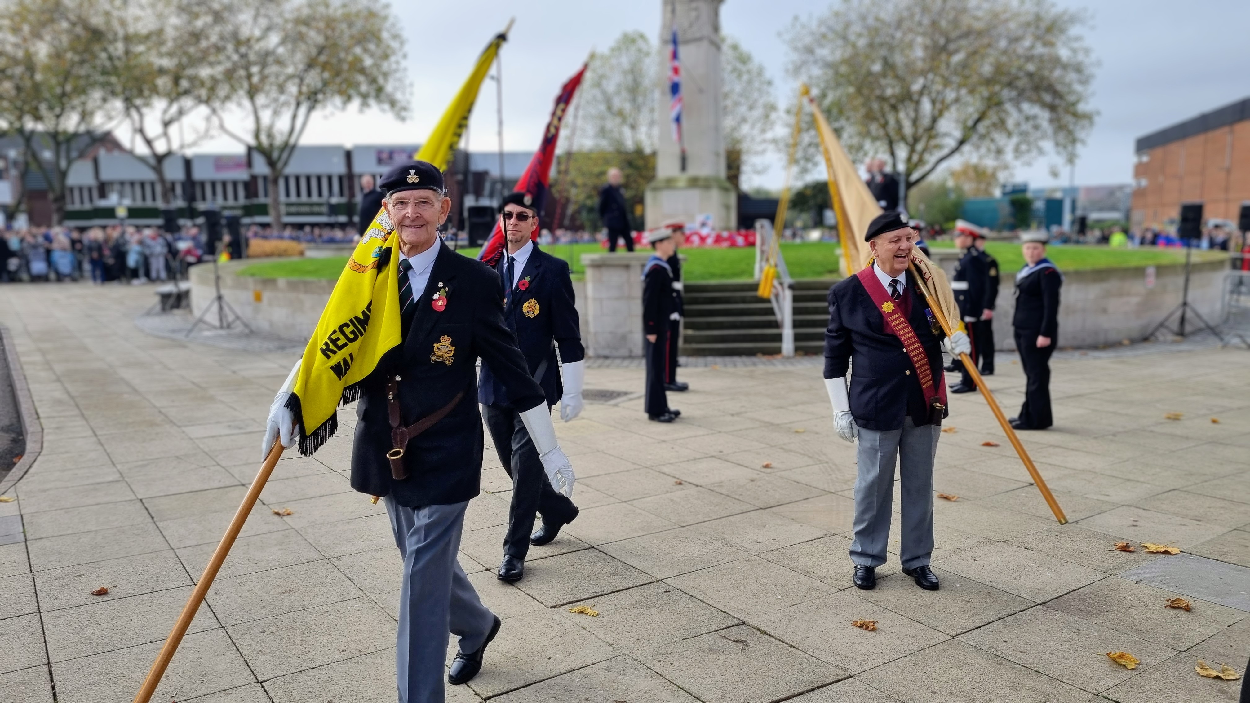 Three flag bearers leaving the Cenotaph 