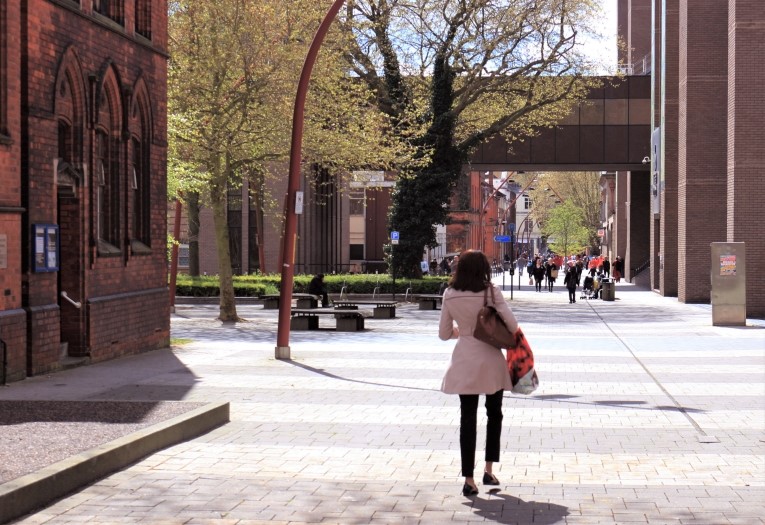 Image shows a woman walking through Darwall Street in Walsall Town Centre