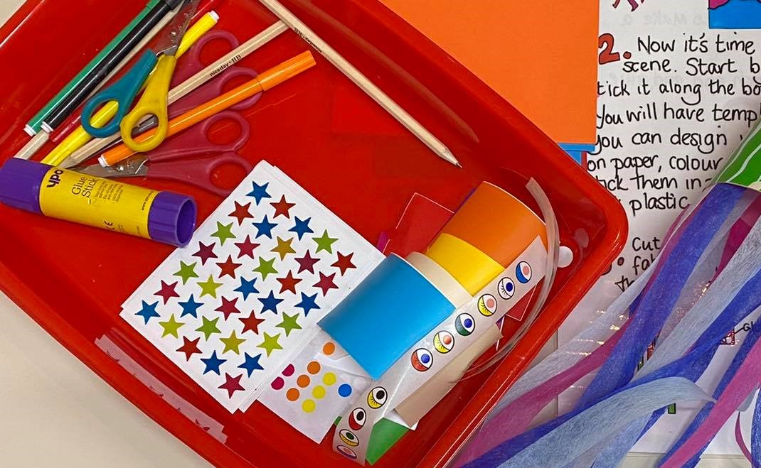 Craft materials including pencils, stickers and scissors
