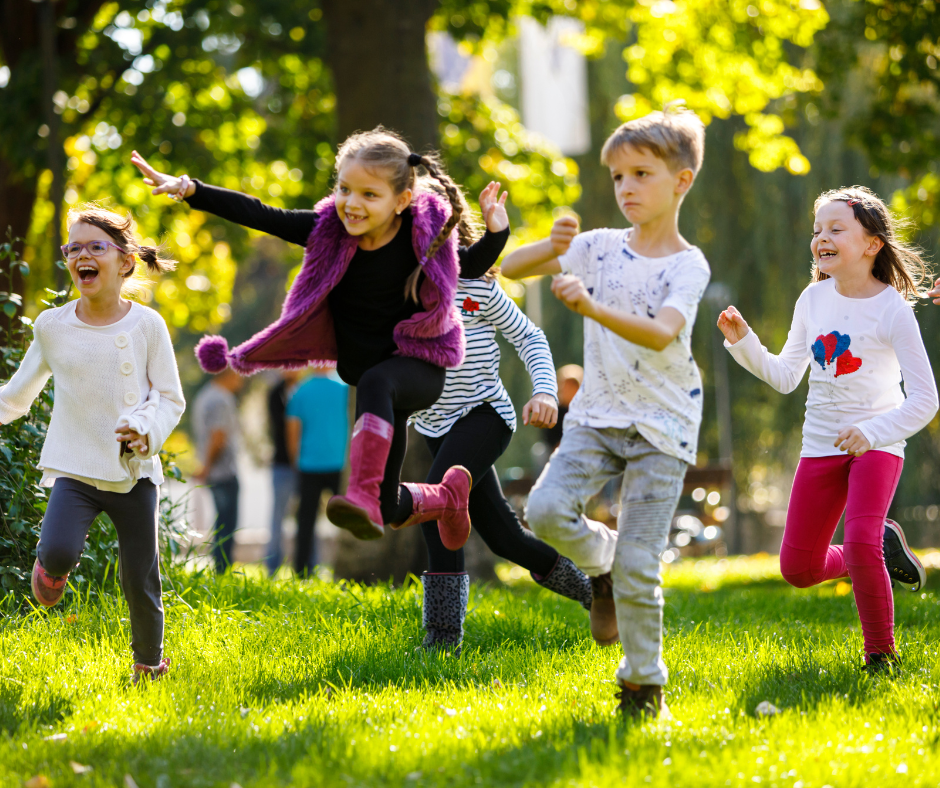 A group of children running and playing outside