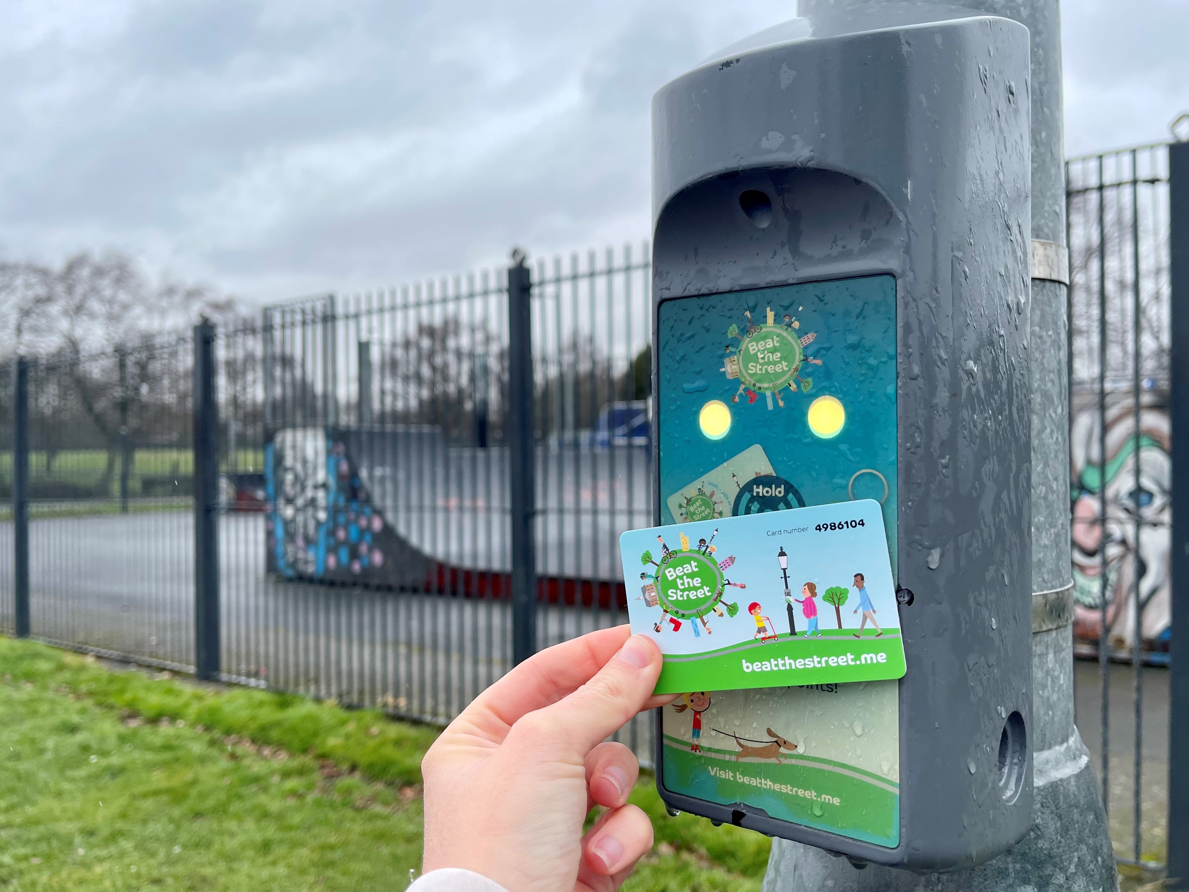 Image shows a Beat the Street card being tapped onto a Beat Box attached to a lamppost.