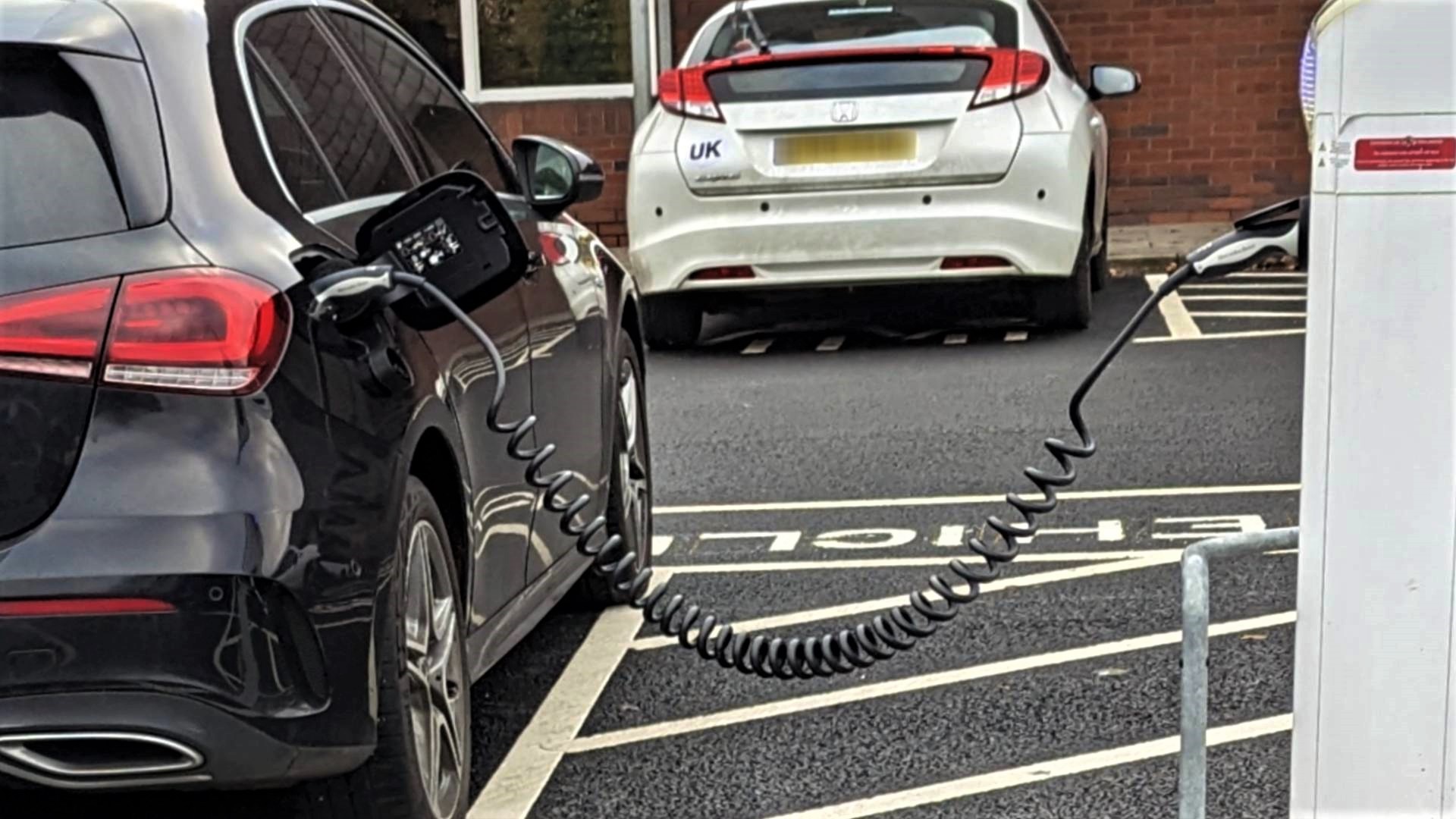 Electric car charge point - black car