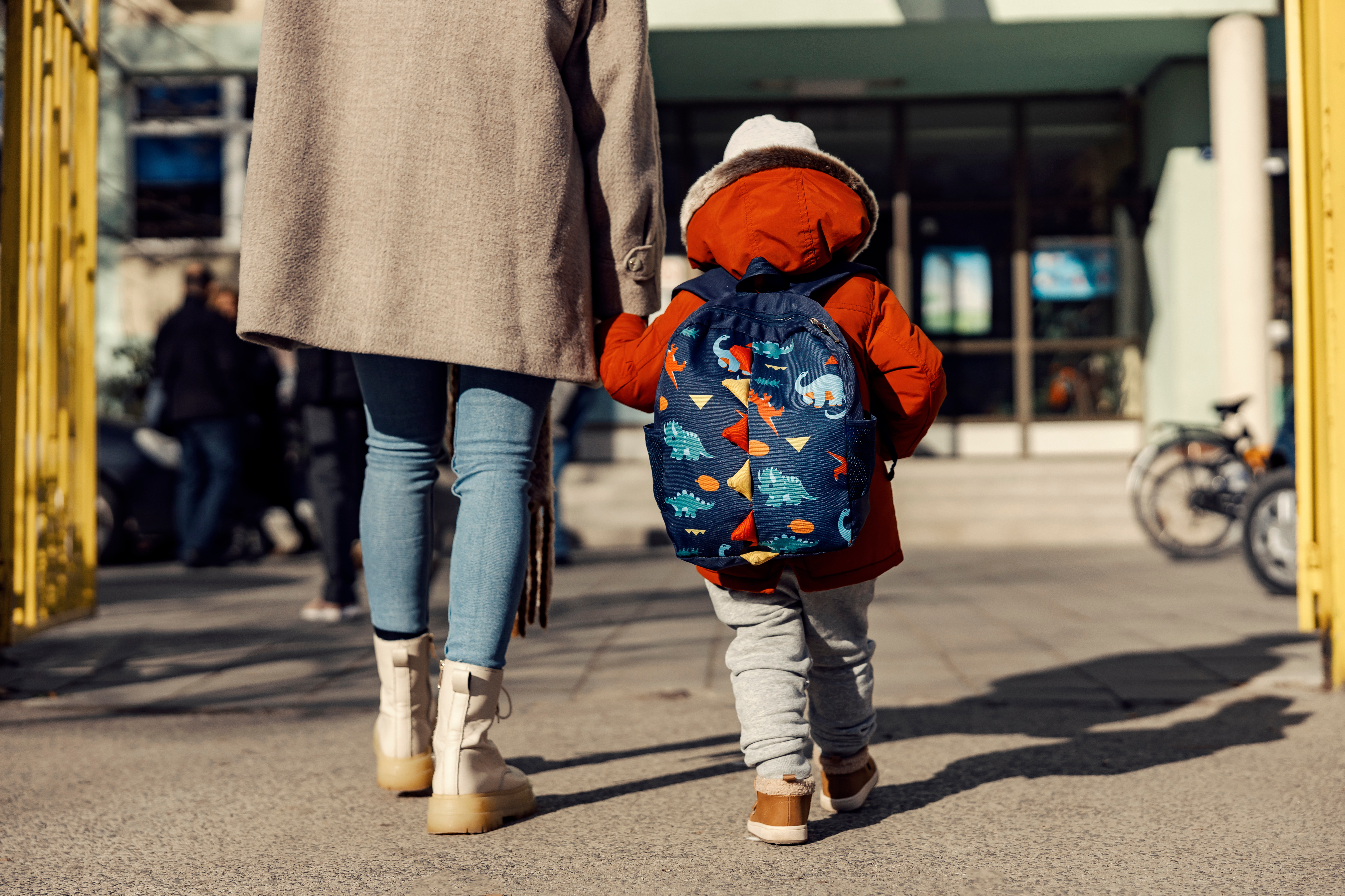 Child and parent walking to school