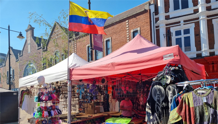 An example of a stall at Walsall's Continental market - a variety of clothing on display under gazebo.