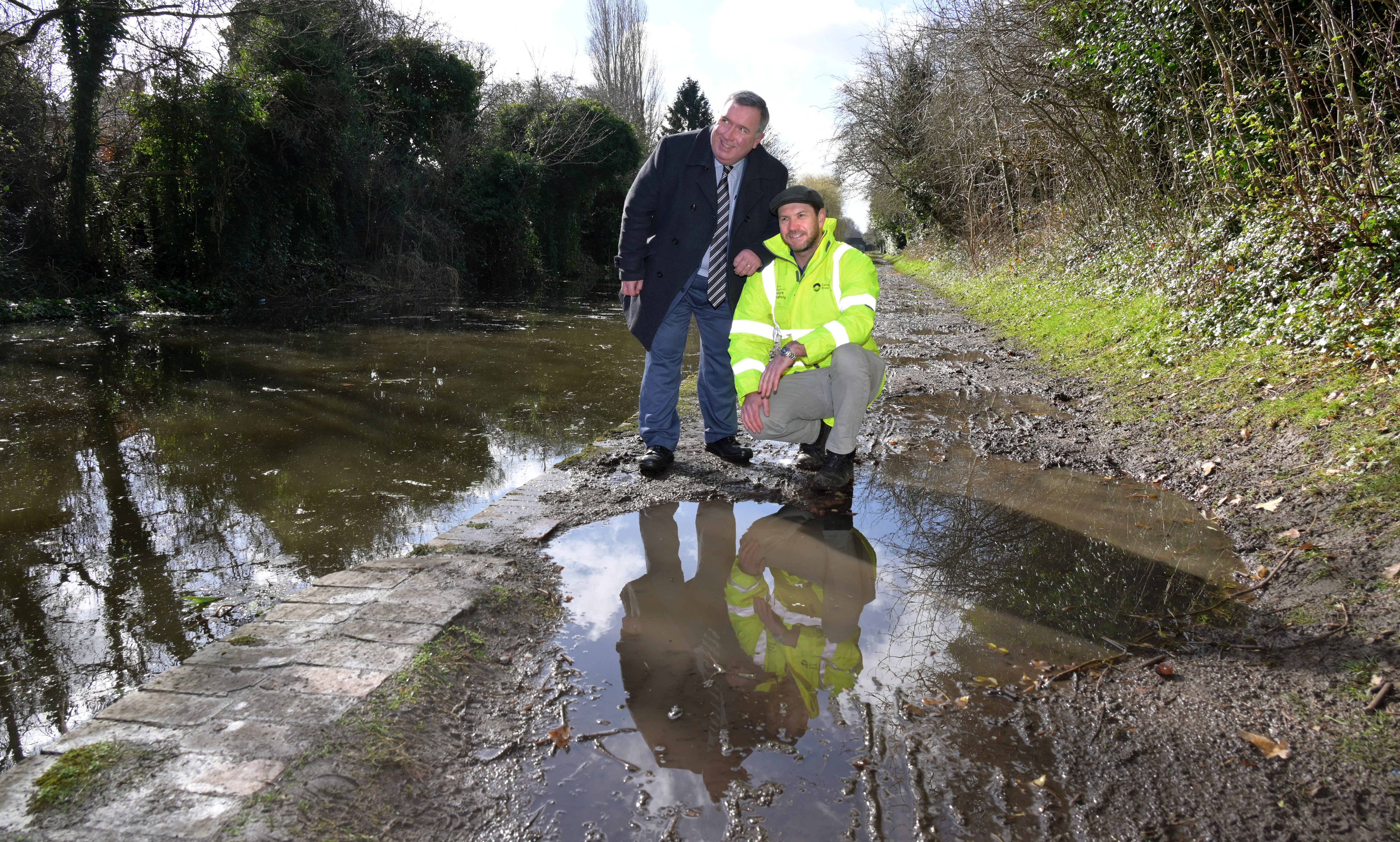 Cllr Andrew and James Dennison from Canal and River Trust looking at the old, worn canal towpath