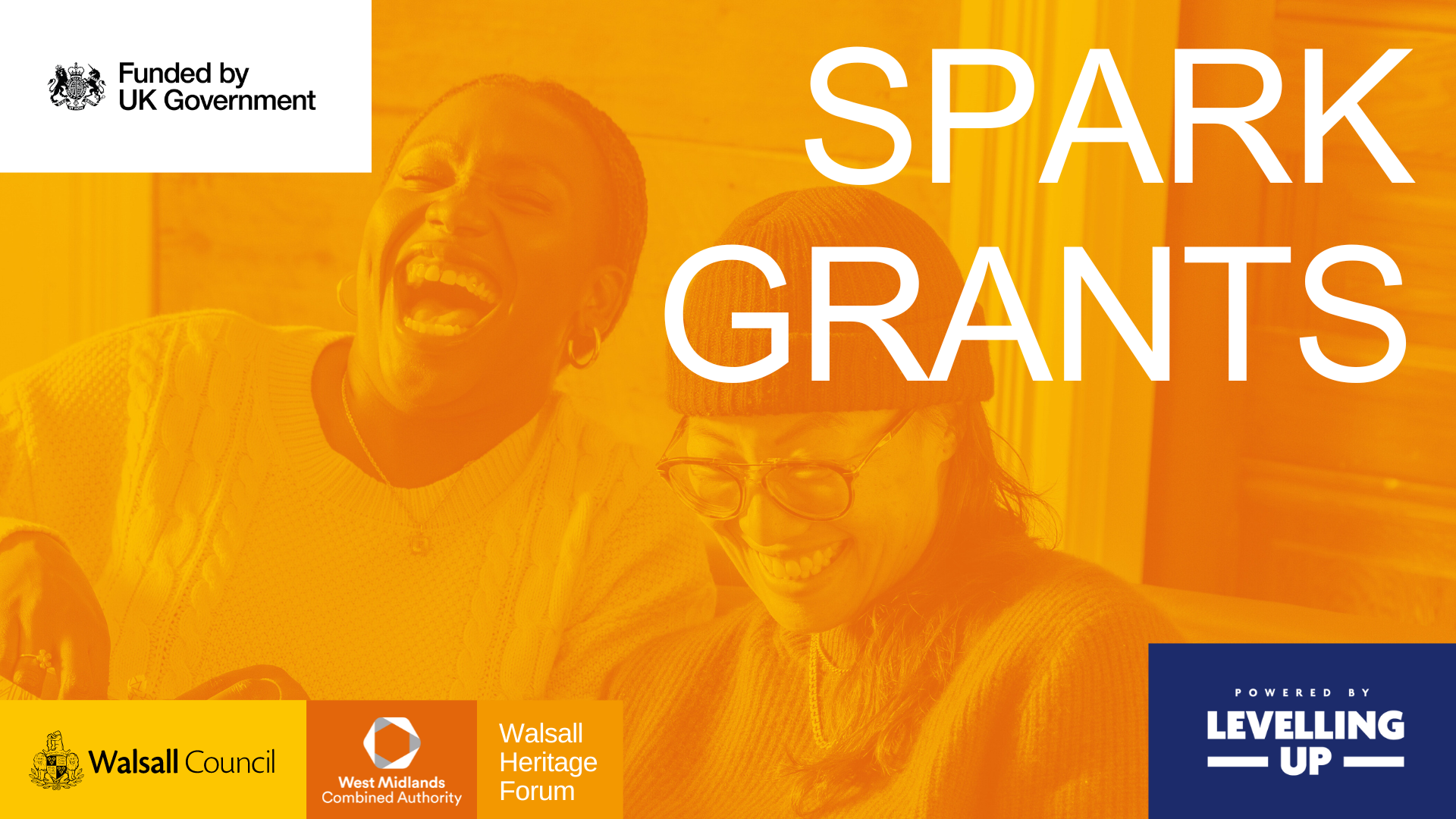 An image of two community members laughing with the words Spark Grants overlaid.