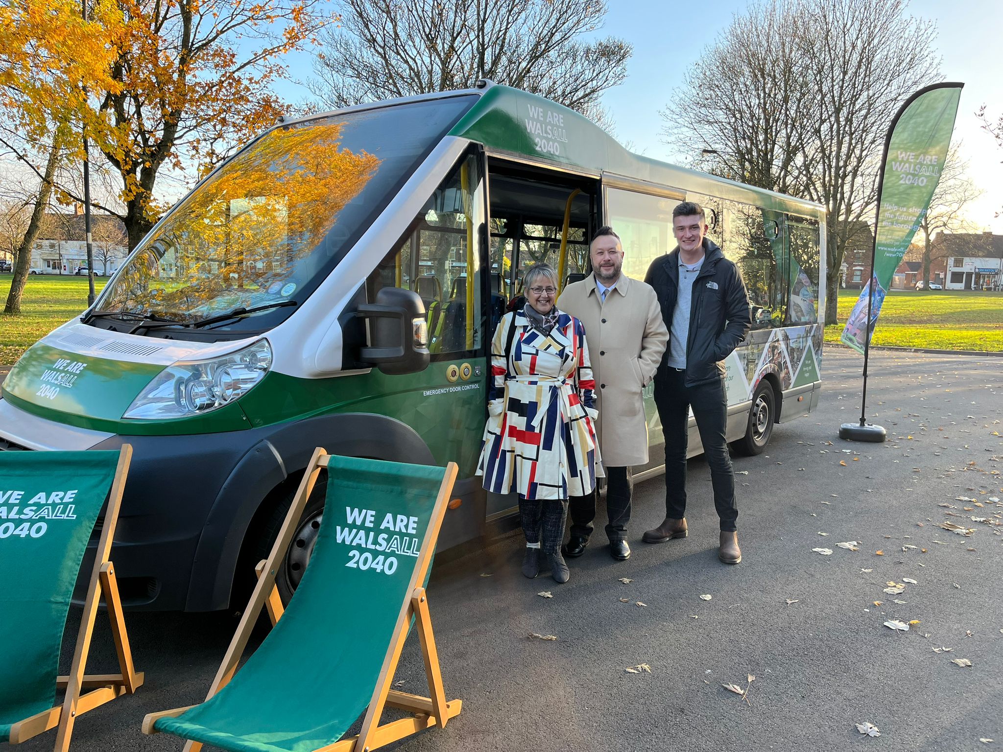 Image depicts the We are Walsall 2040 Roadshow Bus with green deckchairs. Outside the bus is Councillor Kerry Murphy, Councillor Garry Perry and a member of staff from We are Walsall 2040.