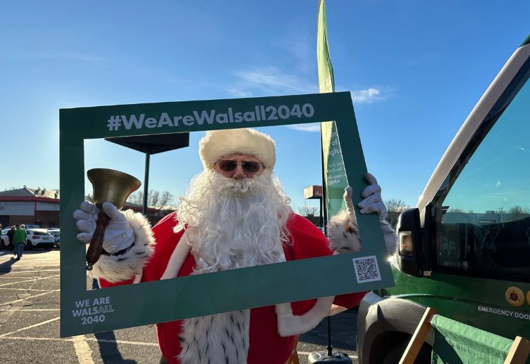 Santa holding a We Are Walsall 2040 frame at Walsall FC