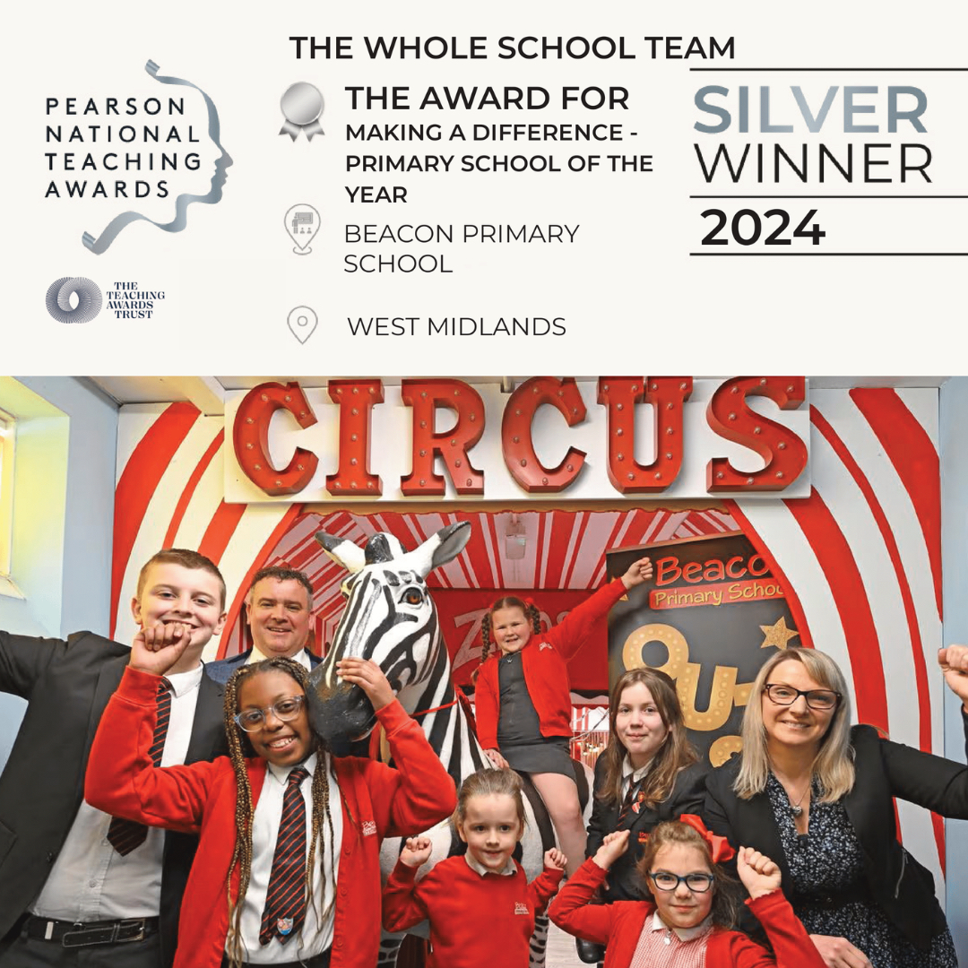 Image depicts children and staff from Beacon Primary School celebrating School of the Year award in front of a circus themed display.
