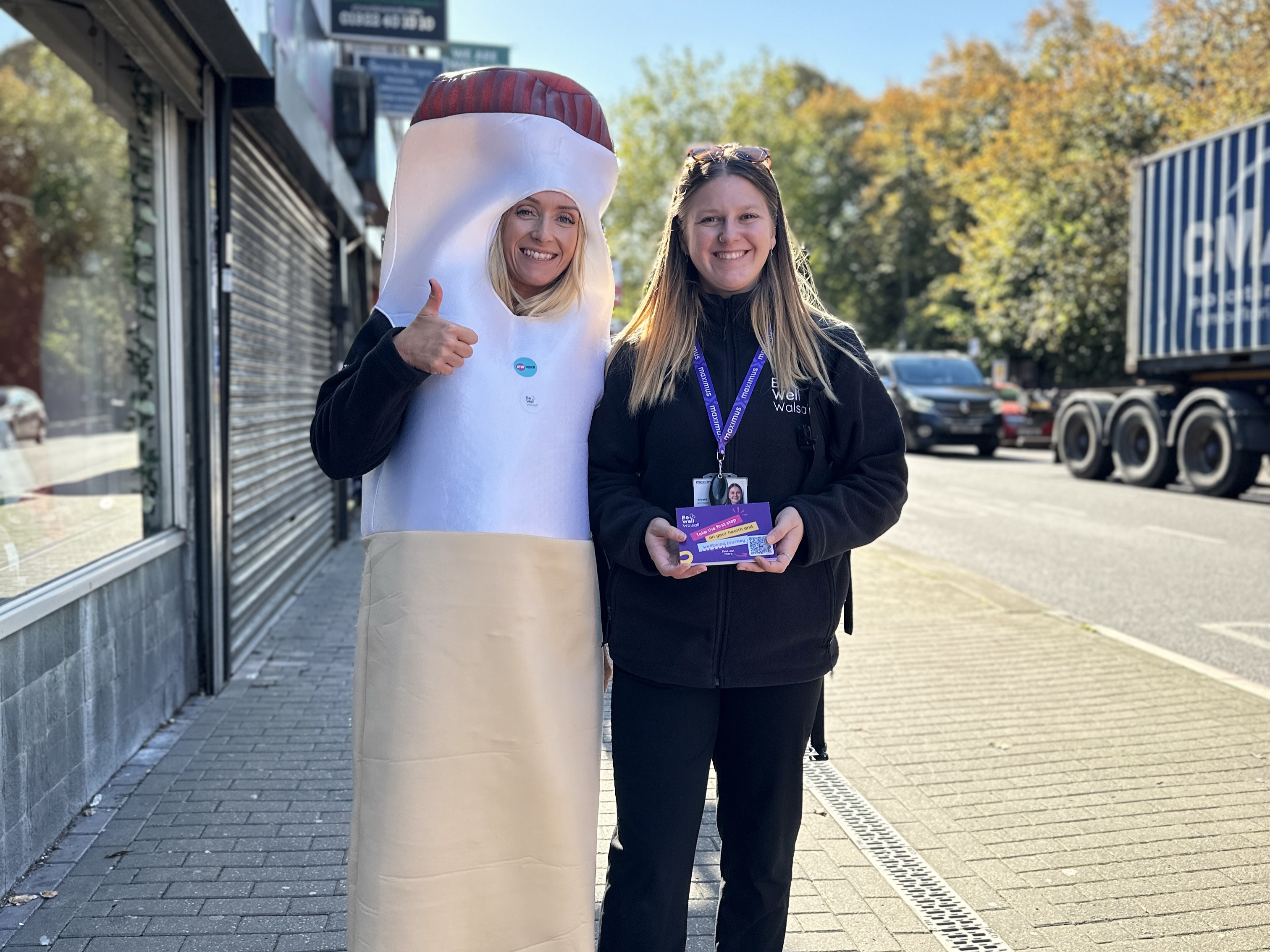 Image depicts members of Be Well Walsall, one of them in a cigarette costume in Bloxwich high street.