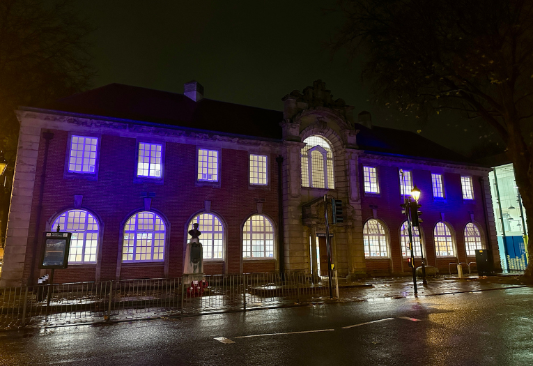 Image depicts the Lichfield Street Hub in Walsall lit up in blue at night.