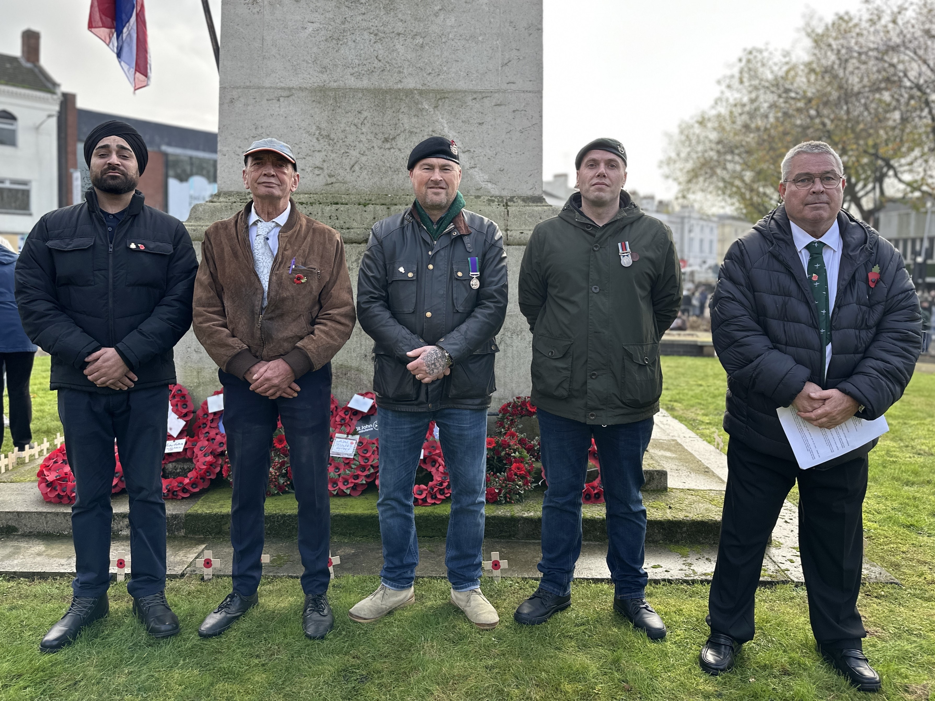 Image depicts five veterans in front of the Walsall town centre cenotaph.