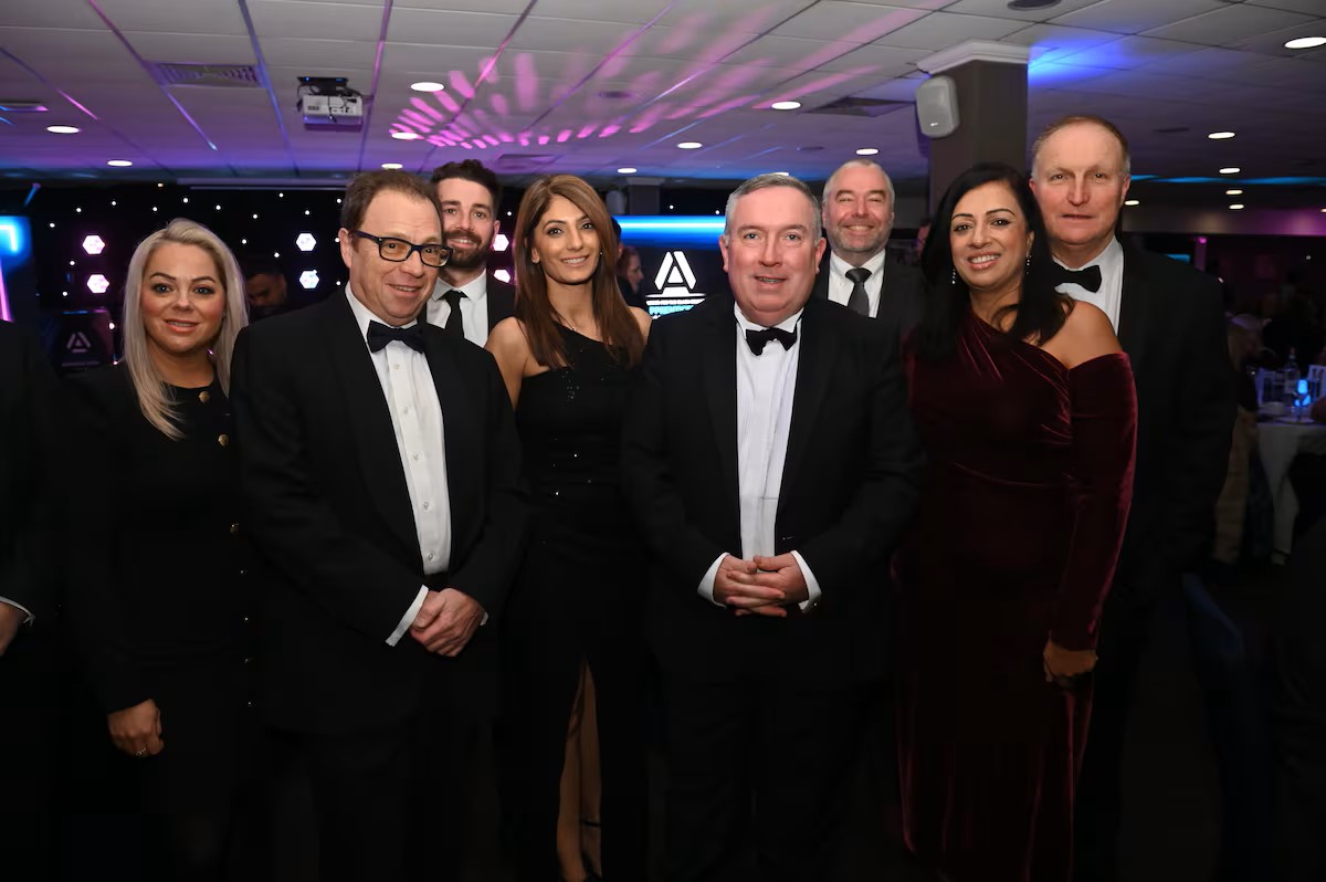 A group photo of people in black tie attire