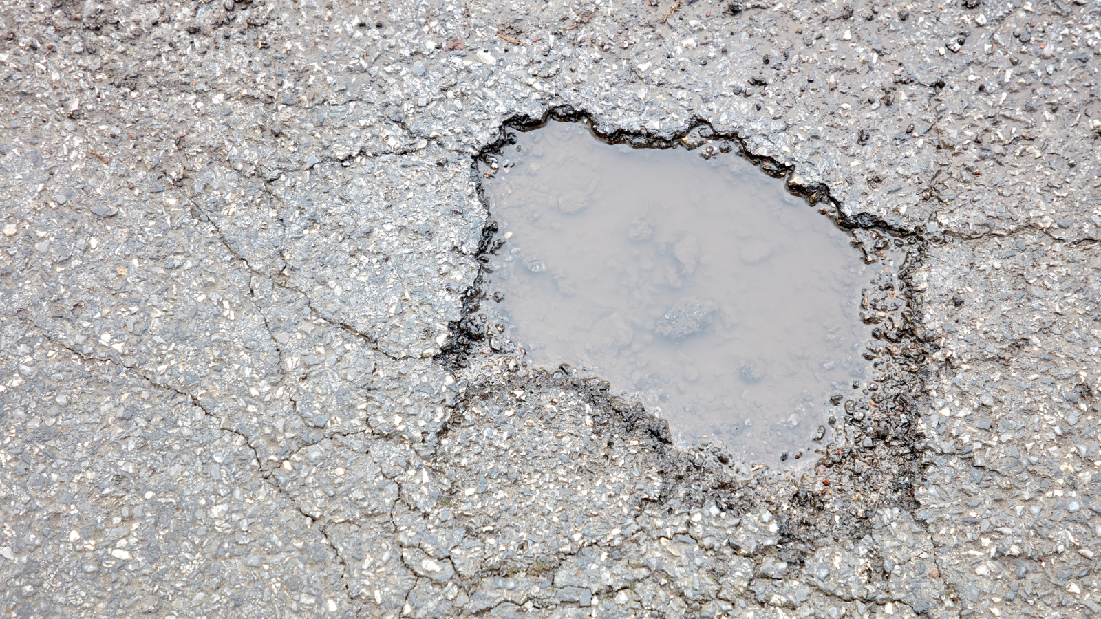 Pothole in road filled with water