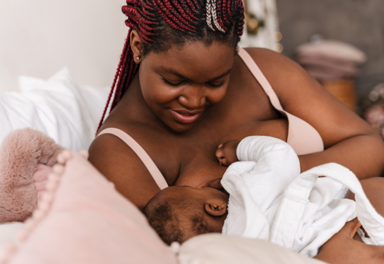 Image depicts a woman breastfeeding her baby.