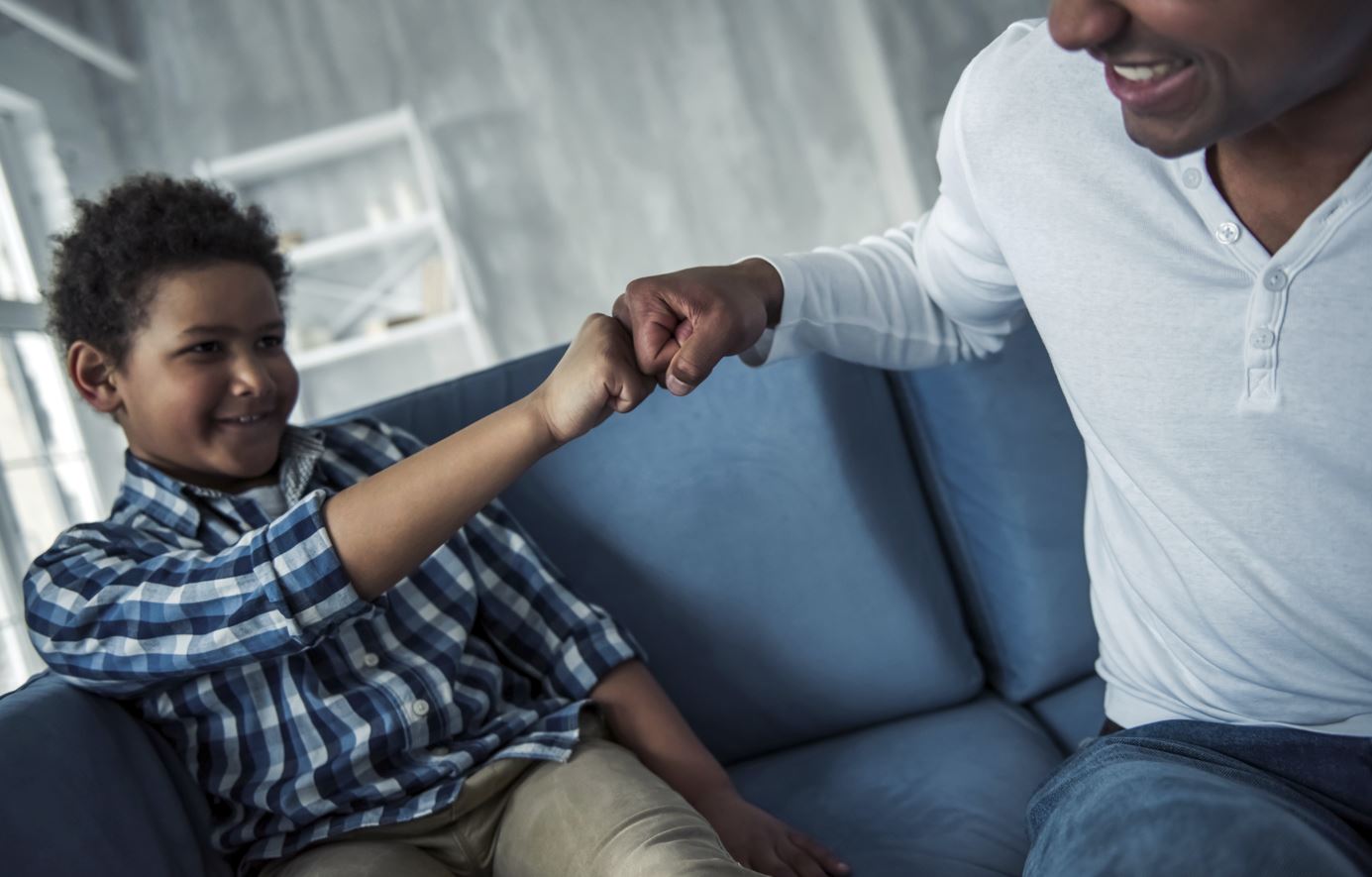 A child and a man fist pumping