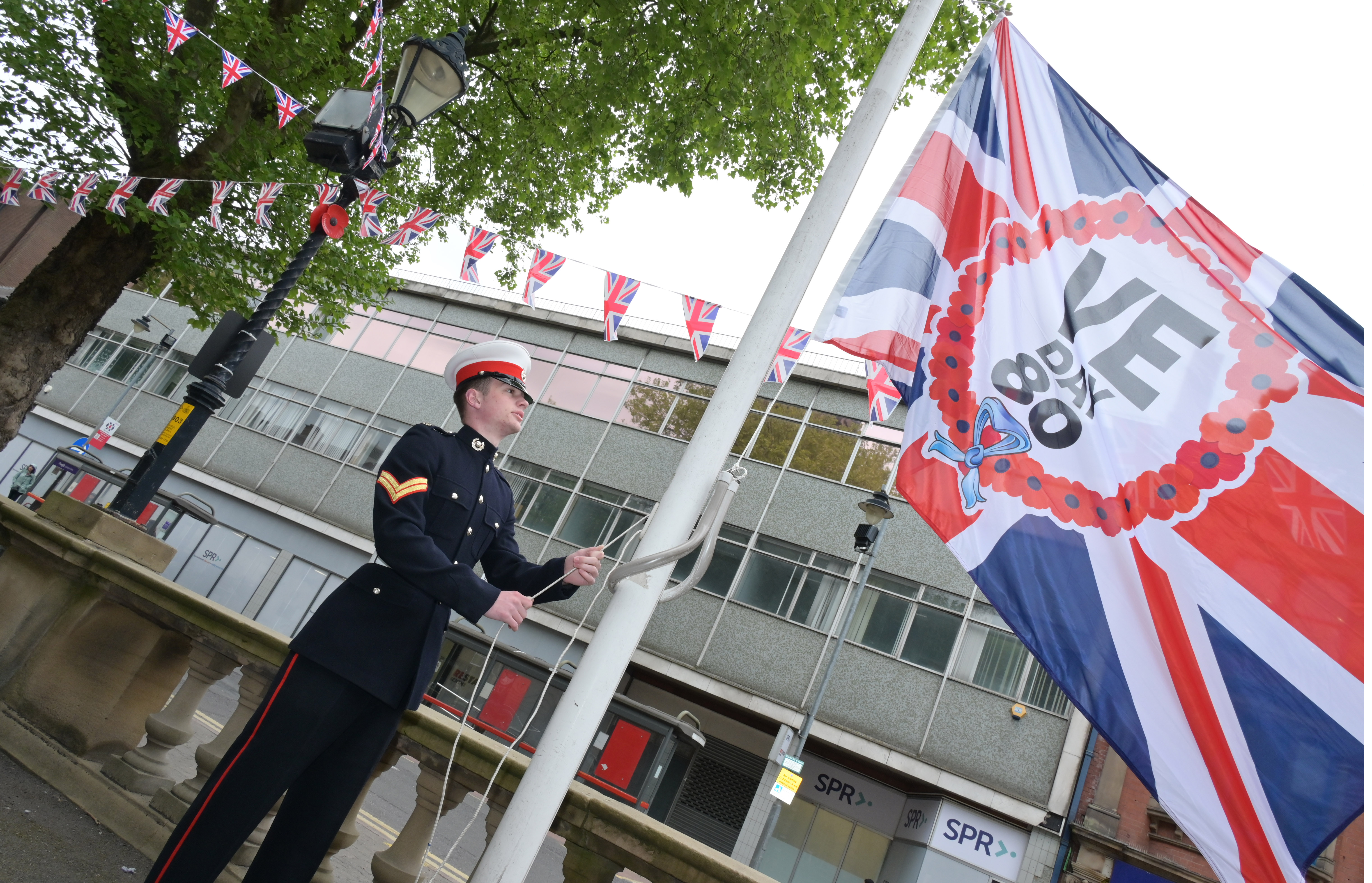 VE day flag being raised outside Walsall Council House