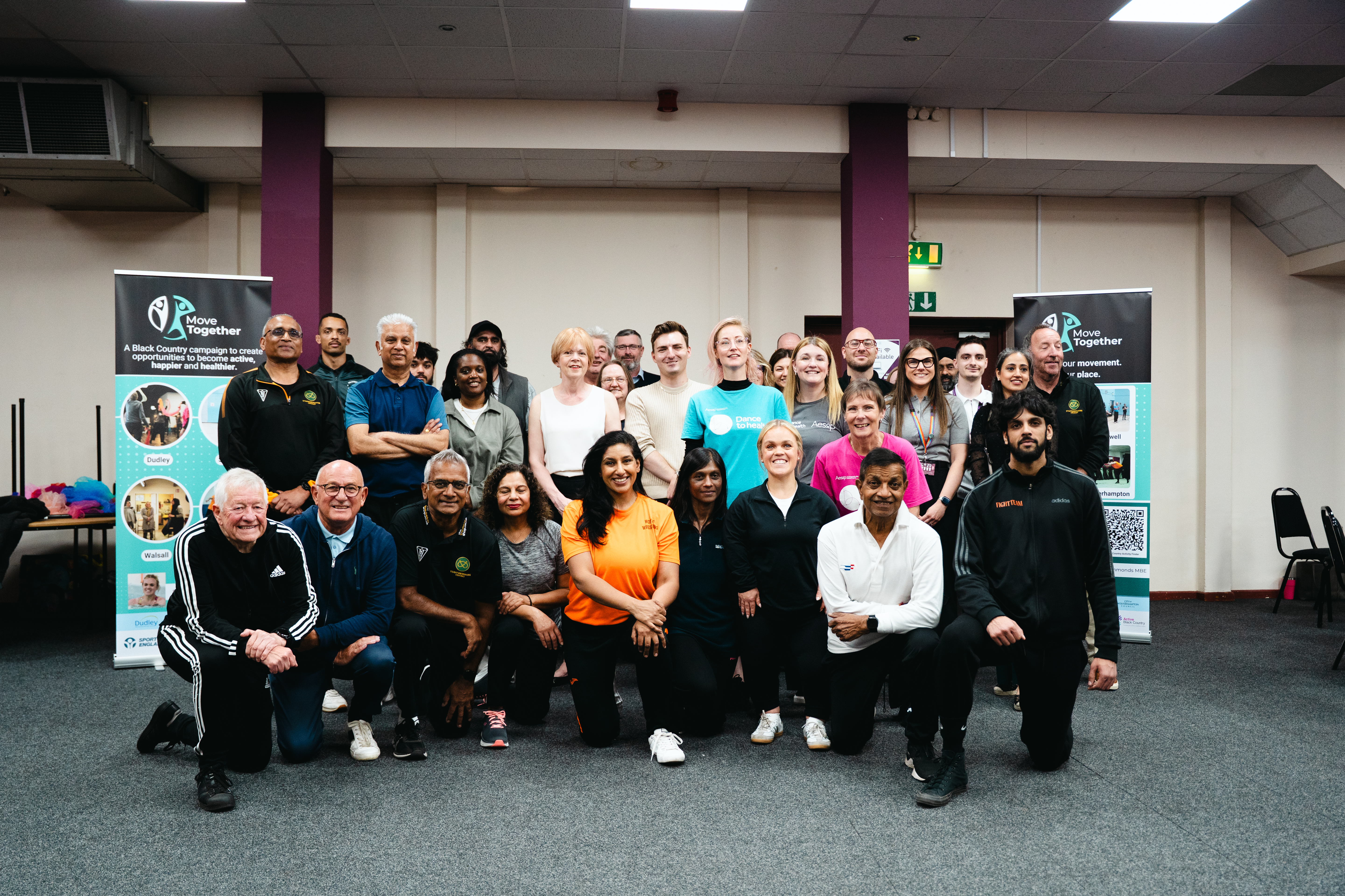 Image depicts a large group of people who attended the Move Together campaign launch at Manor Farm Community Association.