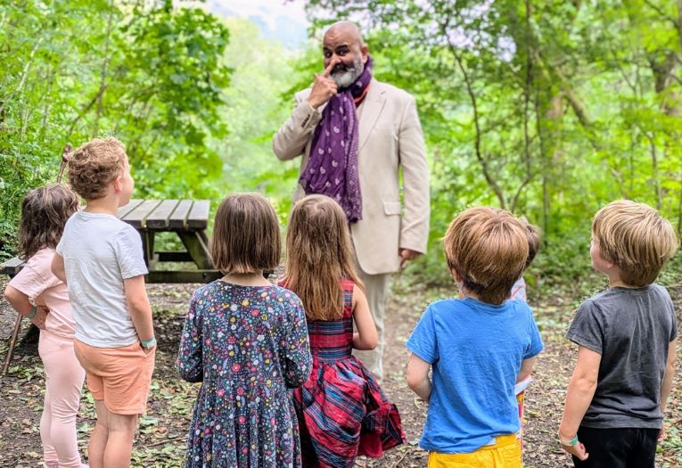 Storyteller Peter Chand in front of a small audience of children