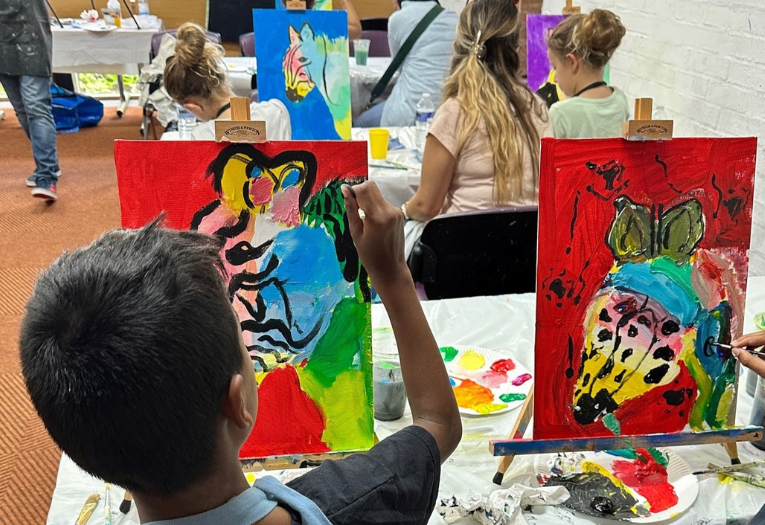 A child painting at an easel