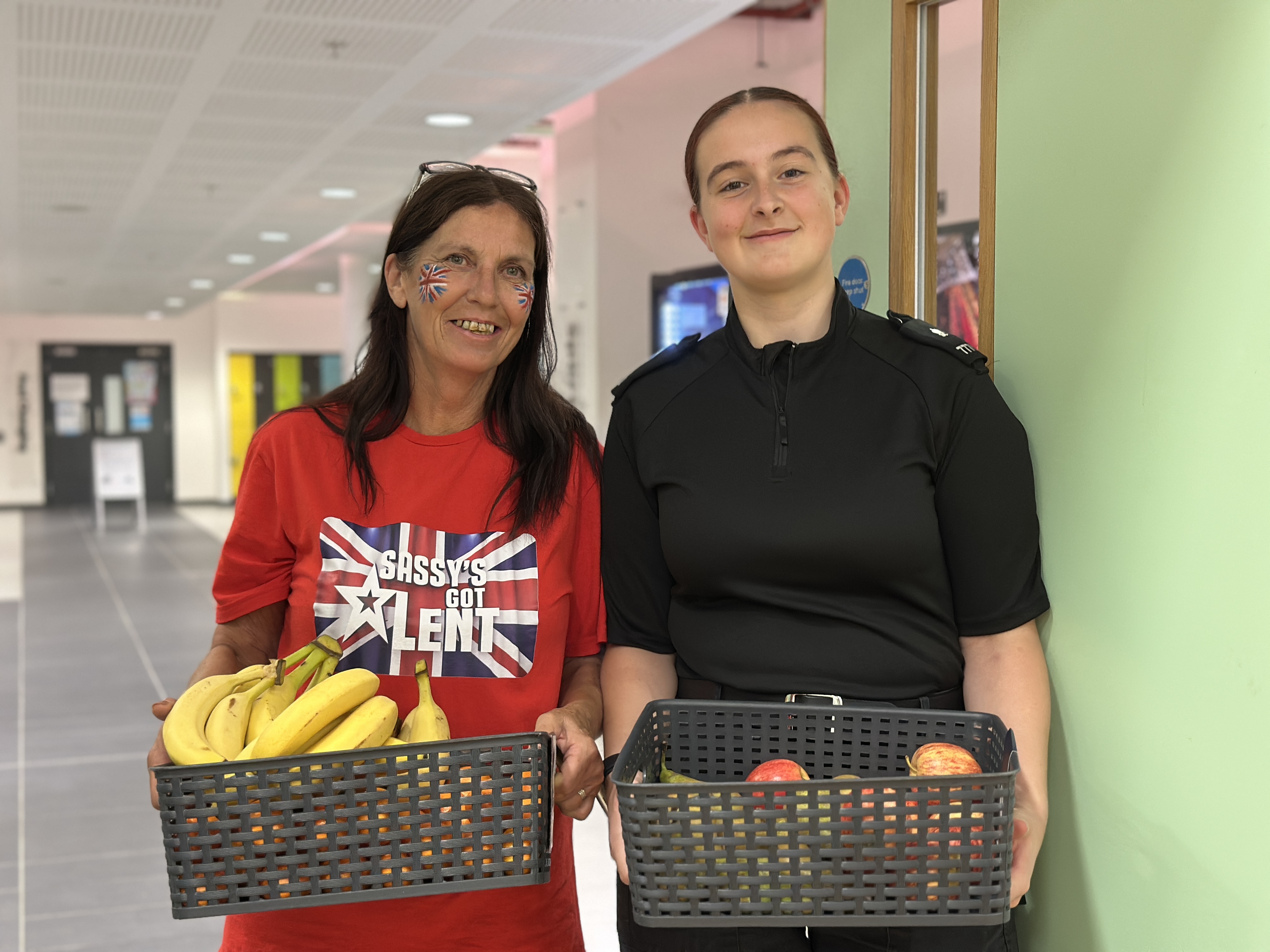 Sassy Sensory Surprises team members holding baskets of fruit at the HAF programme