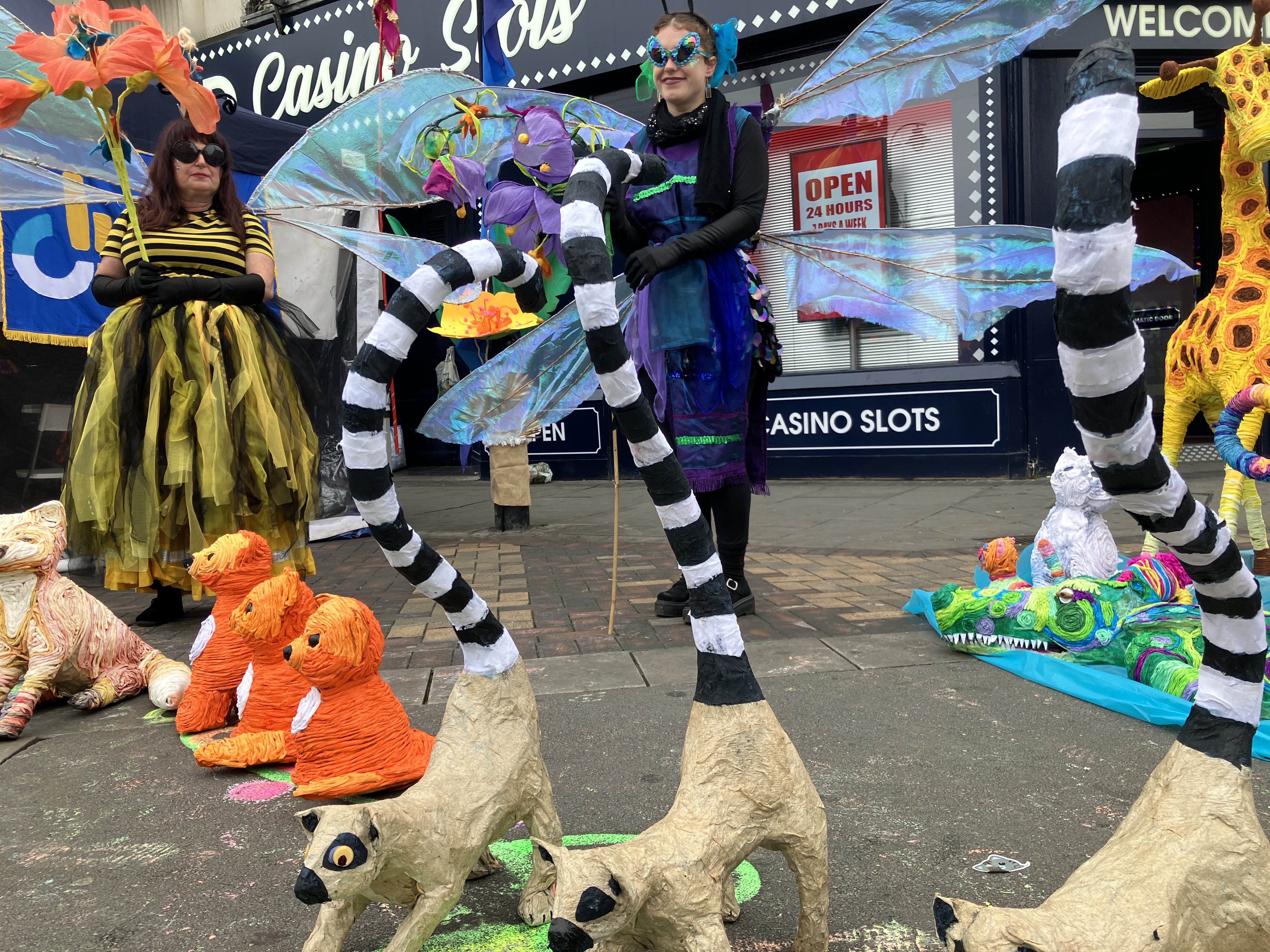 Members of Creative Factory dressed up surrounded by papier mache animals