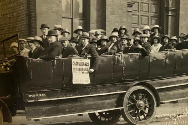 Group of early 20th century daytrippers in a charabanc