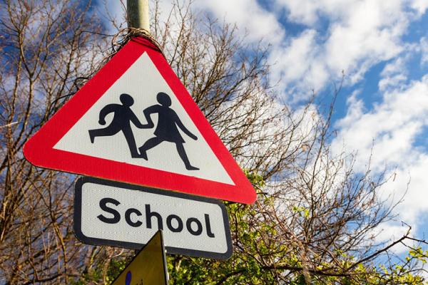 Image of a road sign displaying school children