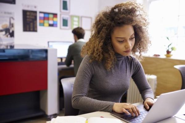 Woman using a laptop in an office