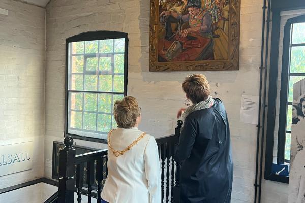 the Mayor of Walsall viewing a painting with museum curator Francesca Cox
