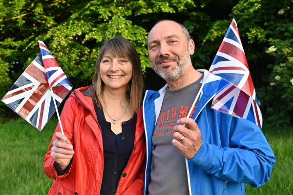 2 people holding British flag