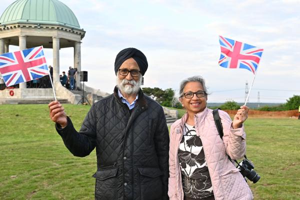 2 people holding British flag