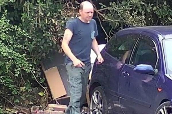 white male in jeans and a blue t shirt fly tipper