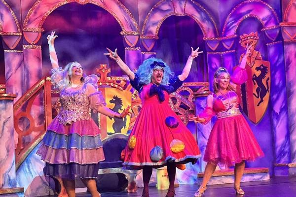 Image depicts three actors on stage performing at Sleeping Beauty panto at Walsall Arena.