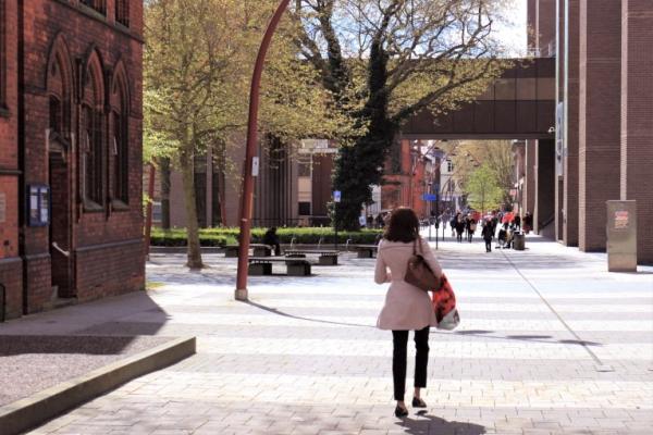 Image shows a woman walking through Darwall Street in Walsall Town Centre