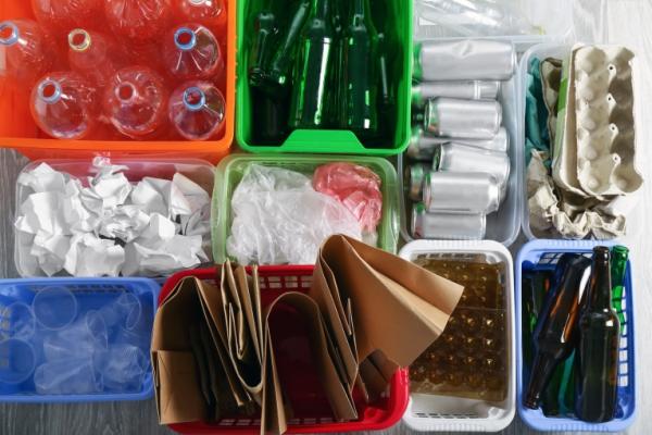 Image shows recycled items in coloured containers.