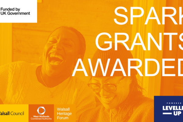 Two people smiling and laughing with the words 'Spark Grants Awarded'