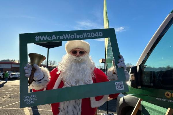 Santa holding a We Are Walsall 2040 frame at Walsall FC