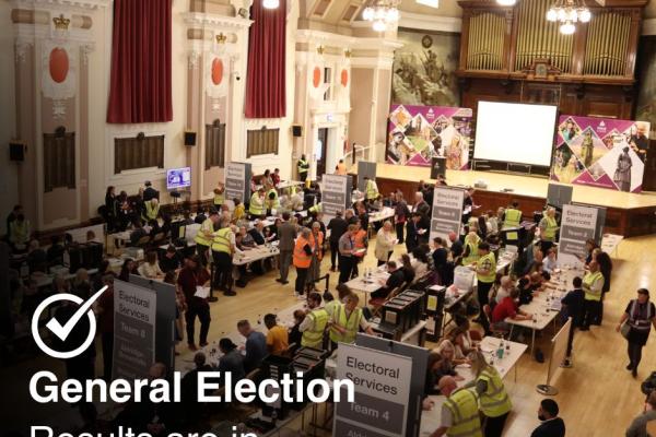 Image depicts the count floor, with text reading 'General Election, Results are in'