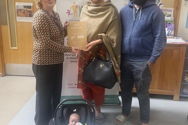 Baby Ibrahim with his parents and the council's registrar.