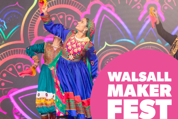 Three dancers in bright South Asian clothing.